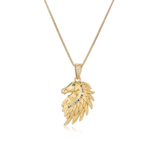 Gold horse head pendant necklace with green and colorful zircon stones on white background