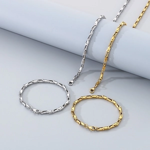 Detail view of titanium steel curb chain bracelets and necklaces in gold and silver finish