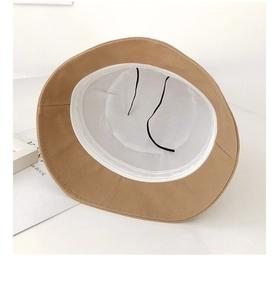 Detail of khaki bucket hat showing breathable white lining and adjustable inner drawstring