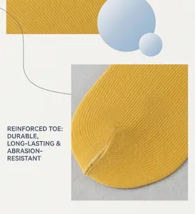 Macro detail of reinforced toe on yellow ribbed socks for increased durability