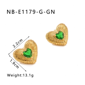 Detail of heart stud earring with green crystal and gold sunburst texture