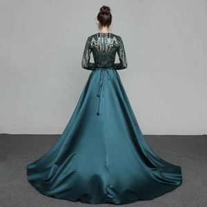 Elegant dark green sequin long-sleeve evening gown with detachable trail and open back