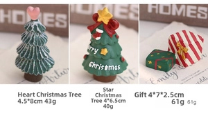 Detailed view of resin Christmas tree miniatures and gift boxes for holiday decor