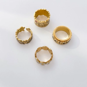 Detailed set of gold rings featuring Keith Haring style art and mahjong rotating elements