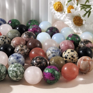 Detailed view of 16mm natural crystal spheres with diverse textures and floral accents