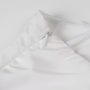 Detailed close-up of a white pleated maxi dress featuring a high-quality invisible back zipper