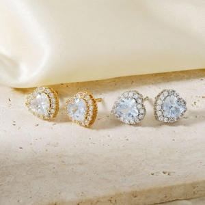 Exquisite heart-shaped stud earrings in gold and silver finish with sparkling zircon stones