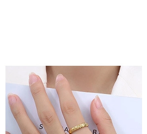 Detailed view of a gold-plated quilted lattice ring worn on the finger with a modern style