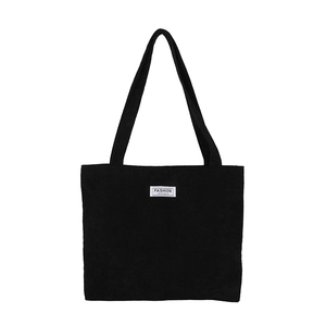 Minimalist black corduroy tote bag with dual straps and fashion logo patch