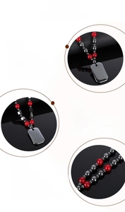 Detail view of hematite beads and polished black rectangular pendant on a braided necklace