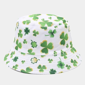 Detail of shamrock print on white foldable bucket hat with green and yellow clover pattern