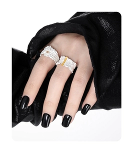 Close-up of irregular textured S925 sterling silver ring with gold plating on model