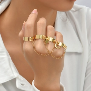 Detailed view of gold multi-finger ring set with star and moon pendants and chains