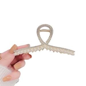 Elegant gold metal hair claw clip featuring sparkling rhinestones and white pearls