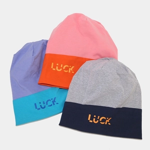 Three colorful knit beanies with LUCK print in pink, purple and grey streetwear style