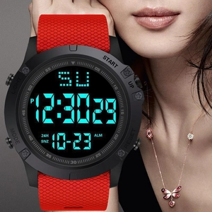 Macro shot of men's digital sports watch with red textured silicone strap on wrist
