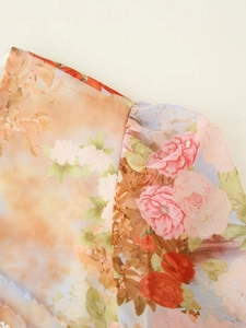 Close-up of floral print dress showing delicate lace stitching and chiffon fabric texture
