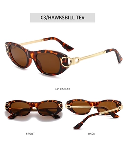Détail de lunettes de soleil ovales en écaille avec branches évidées en métal