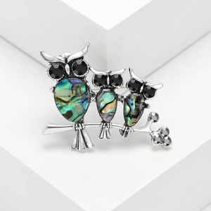 Retro owl trio brooch featuring iridescent abalone shell inlay on a silver branch