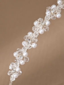 Macro shot of silver wire bridal headband featuring crystal beads and white faux pearls