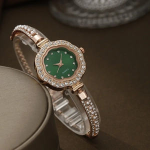 Detail of rose gold quartz watch featuring a green petal dial and rhinestone accents