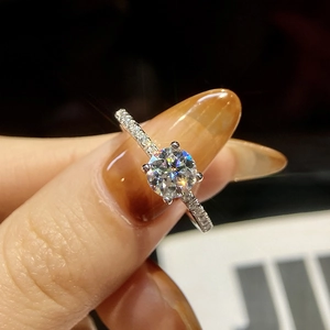 Macro shot of silver S925 ring with a sparkling round moissanite and pave diamonds