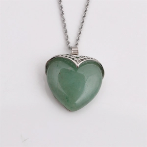 Green heart-shaped gemstone pendant necklace with silver twisted chain on grey background