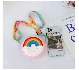 Close-up of pink round silicone kids crossbody bag with rainbow and colorful strap