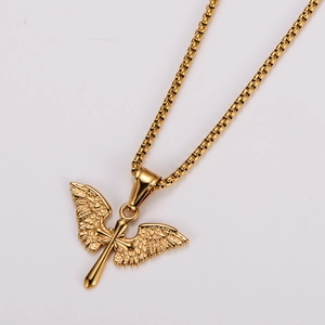 Detail of golden cross pendant with angel wings featuring intricate feather texture