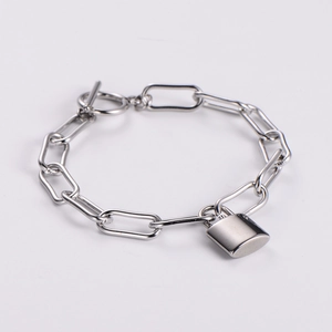 Polished silver chain bracelet with lock pendant and toggle clasp on a white background