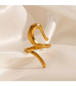 Detail of gold-plated curved ring with a brushed metal texture on soft white silk fabric