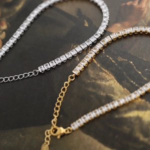 Macro shot of silver and gold square zircon tennis bracelets with secure clasps