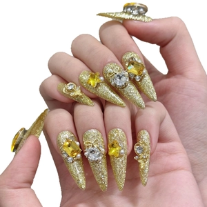 Luxurious gold glitter stiletto handmade press-on nails with 3D crystal butterfly charms
