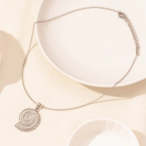 Detailed close-up of a silver nautilus shell pendant on a polished stainless steel chain