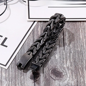 Detail of gunmetal dragon bone punk chain bracelet with a heavy-duty fold-over clasp