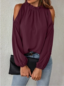 Detail of burgundy cold-shoulder blouse featuring pleated high neck and smocked cuffs
