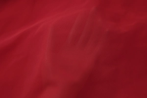 Gros plan détaillé du tissu mousseline rouge foncé avec éclat soyeux et des plis souples