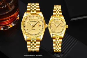 Luxury gold-tone couple watches with date display and fluted bezel details