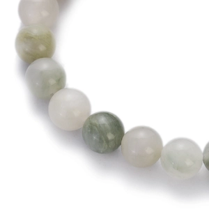 Macro shot of colorful natural stone beads with smooth texture and green gradients