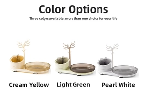 Rotating makeup organizer trays with jewelry trees in cream yellow, green, and white colors