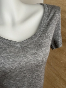 Close-up of V-neckline on grey tencel wool knit t-shirt with soft textured fabric