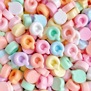 Close-up of colorful Q-shaped resin alphabet beads for DIY hair clip accessories