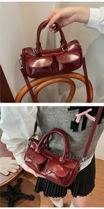 Detail of burgundy patent leather saddle bag with double front pockets and silver hardware