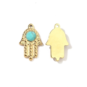Detail of gold Hamsa hand charms with turquoise stone inlay and polished metal back