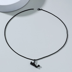 Detailed view of hip hop soccer cleat and ball pendant on black metal necklace chain