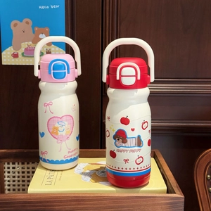Detail of cute stainless steel kids tumblers with handle and press lid on wooden tray