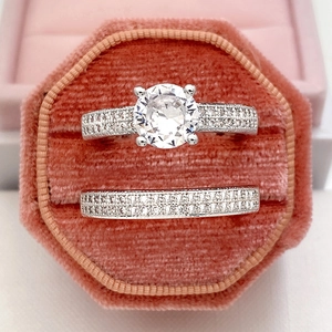 Macro shot of a classic round-cut diamond ring set in a pink velvet jewelry gift box