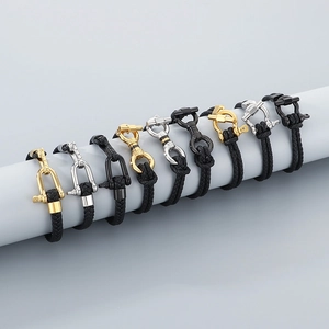 Detailed close-up of woven horseshoe buckle bracelets in gold, silver and black finishes