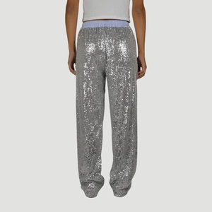 Close-up of silver sequin wide-leg pants showing high-waist fit and shiny texture details