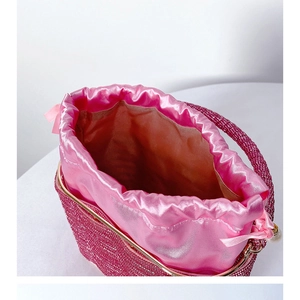 Detailed macro view of the rose pink sequined evening bucket bag with smooth satin lining